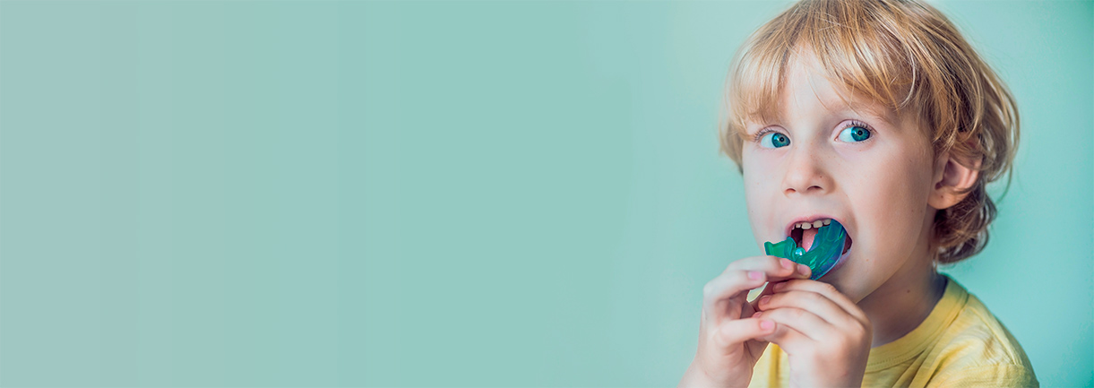 child playing with a gel denture