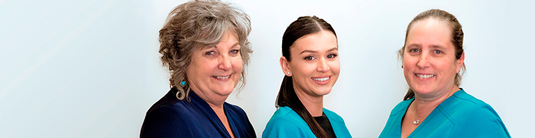 three assistants smiling