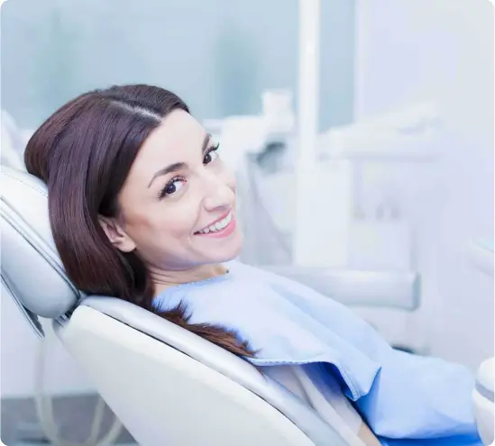 A smiling woman sitting in a dental chair