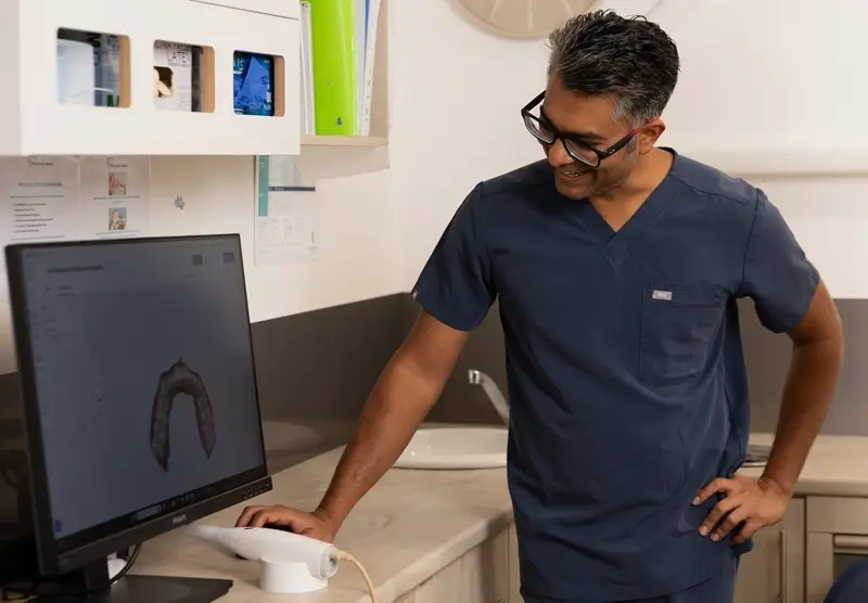 Dentist discussing upper arch dental scan with patient
